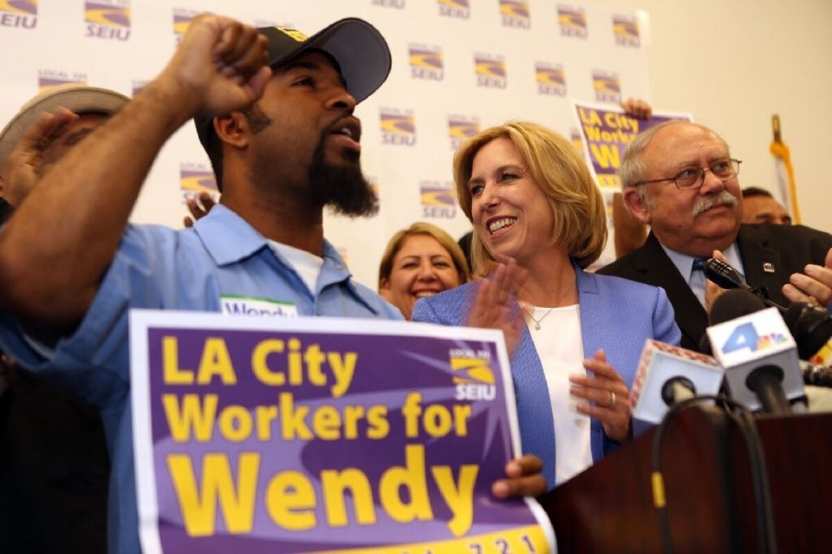 Wendy Greuel is joined by supporters Simbowa Wright, left, and Bob Schoonover of SEIU Local 721 during a March campaign stop in Sun Valley.