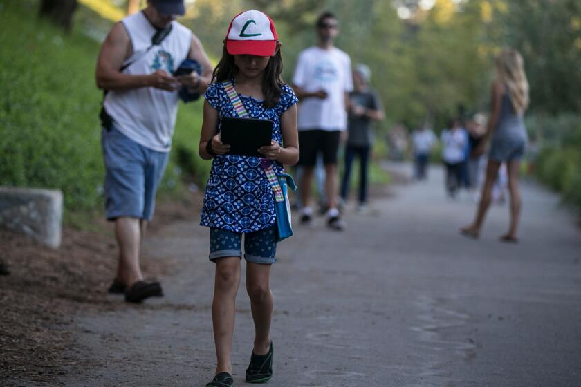 An 8-year-old plays Pokemon Go in Mission Viejo. The American Academy of Pediatrics advises parents to limit kids' time with digital devices and TV.
