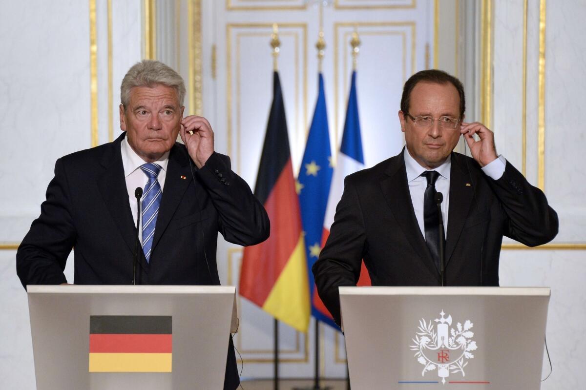 French President Francois Hollande, right, and his German counterpart Joachim Gauck give a joint news conference after a meeting at the Elysee Palace in Paris.