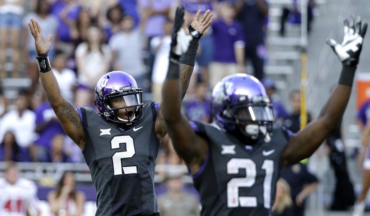 TCU quarterback Trevone Boykin (2) and running back Kyle Hicks (21) celebrate after a touchdown against Texas Tech in the second half of a game on Oct. 25.