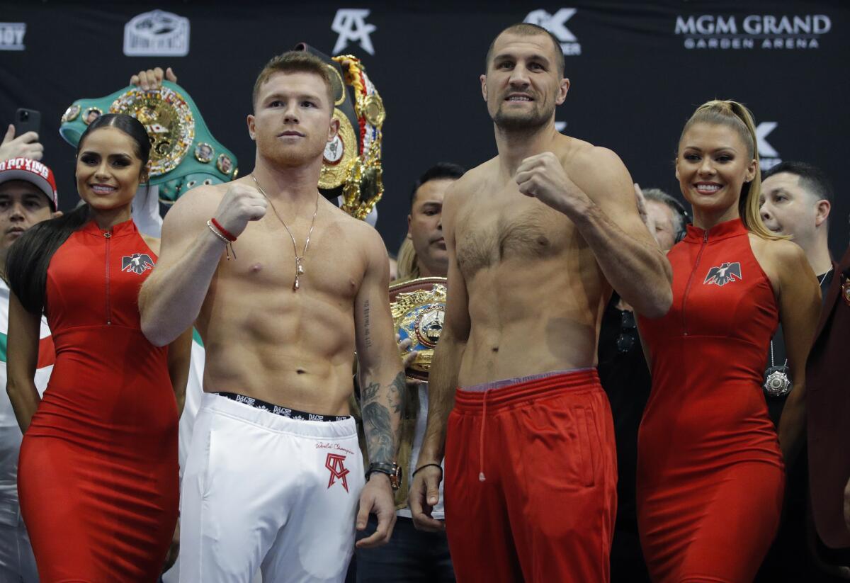Canelo Alvarez, left, and Sergey Kovalev pose during their weigh-in Friday in Las Vegas.