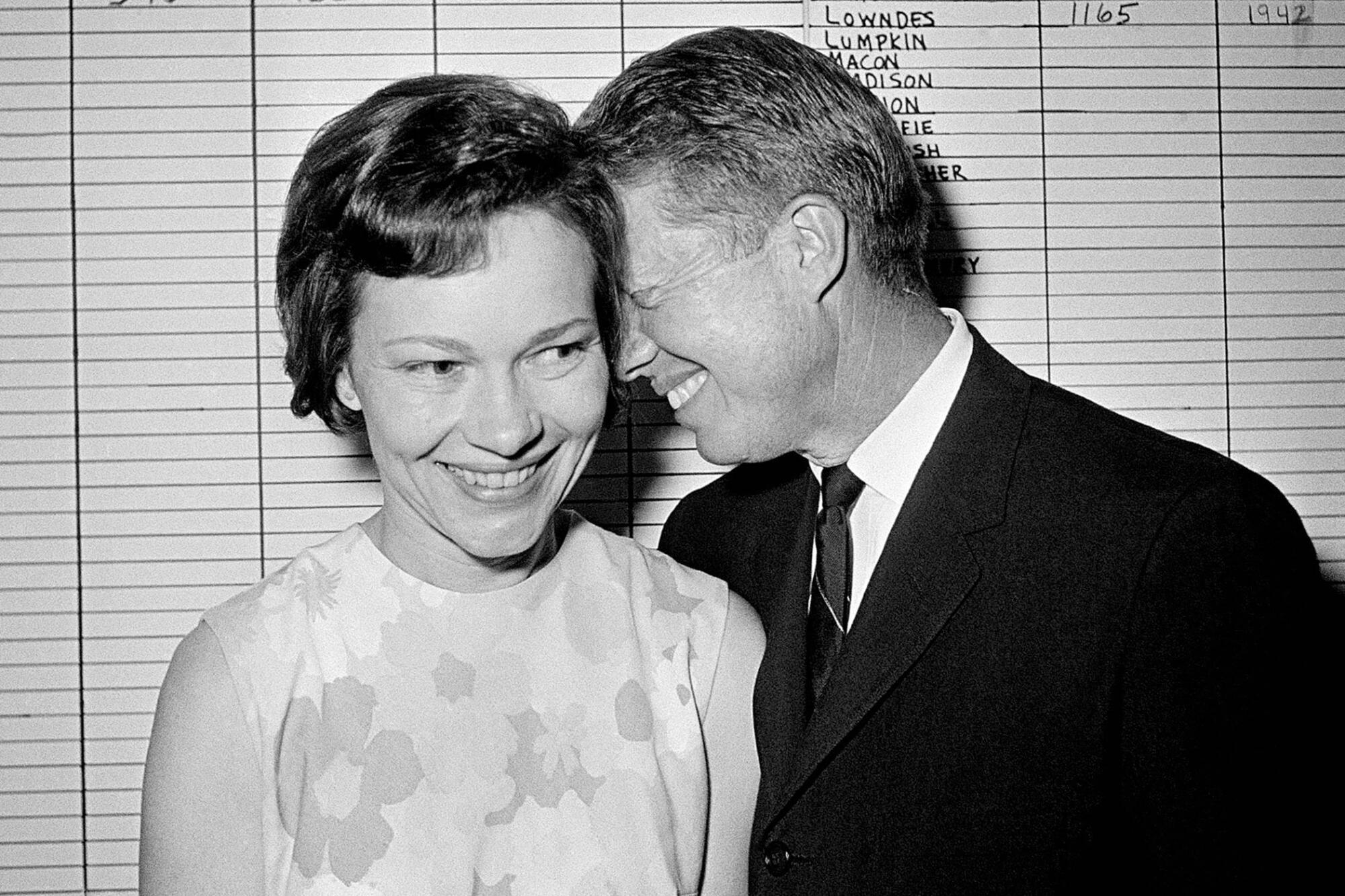 Rosalynn and Jimmy Carter stand together smiling.