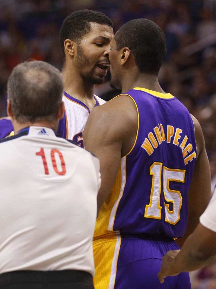 Forwards Metta World Peace of the Lakers and Markieff Morris of the Suns have a few words for each other during the first half Saturday night in Phoenix.