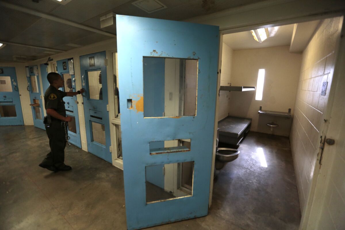 A deputy checks on one of the inmates in the High Observation Mental Health Housing unit at the Twin Towers Correctional Facility in 2015.
