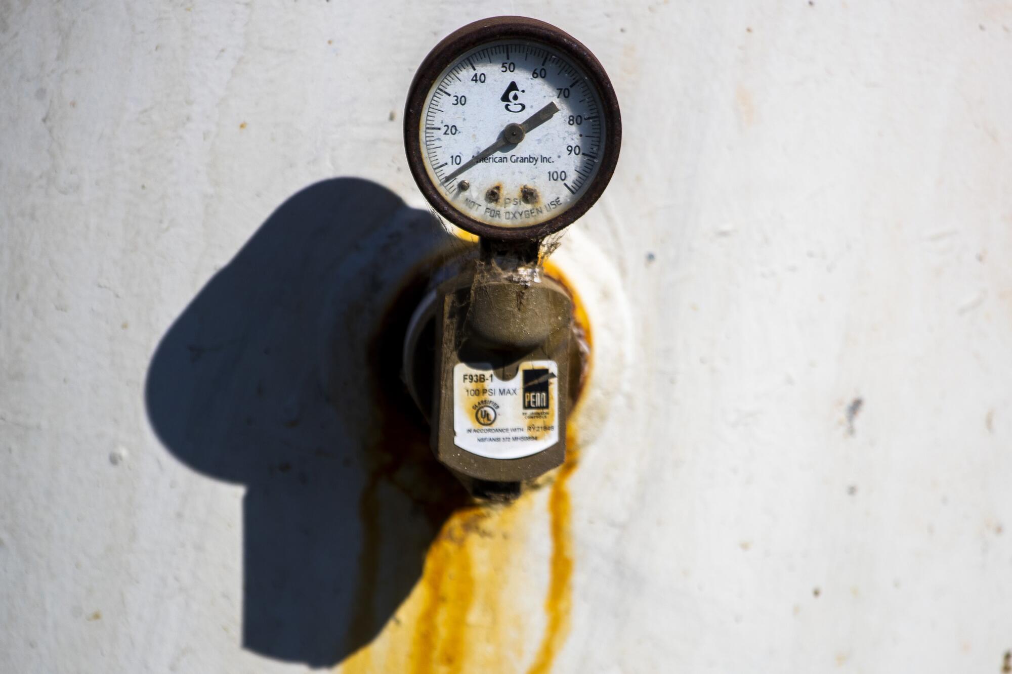 A water gauge shows only a few pounds of pressure in a well.