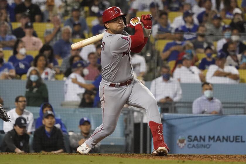 The Angels' José Iglesias drives in a run with a double during the 10th inning against the Dodgers on Aug. 6, 2021.