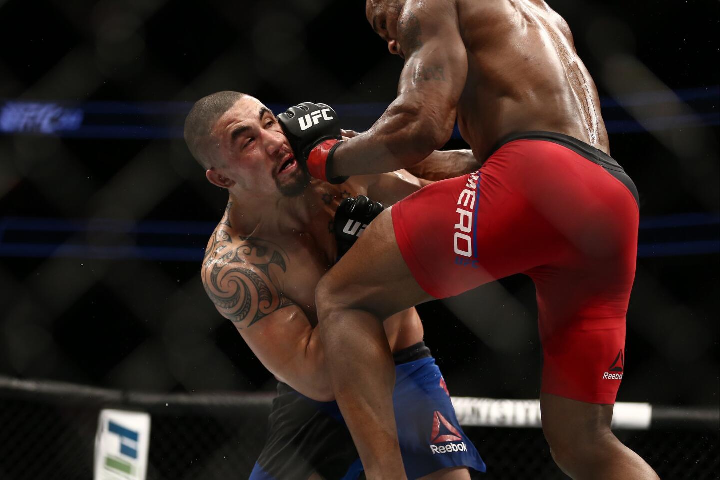 Yoel Romero knees Robert Whittaker in their interim UFC middleweight championship bout during the UFC 213 event at T-Mobile Arena on Saturday in Las Vegas.