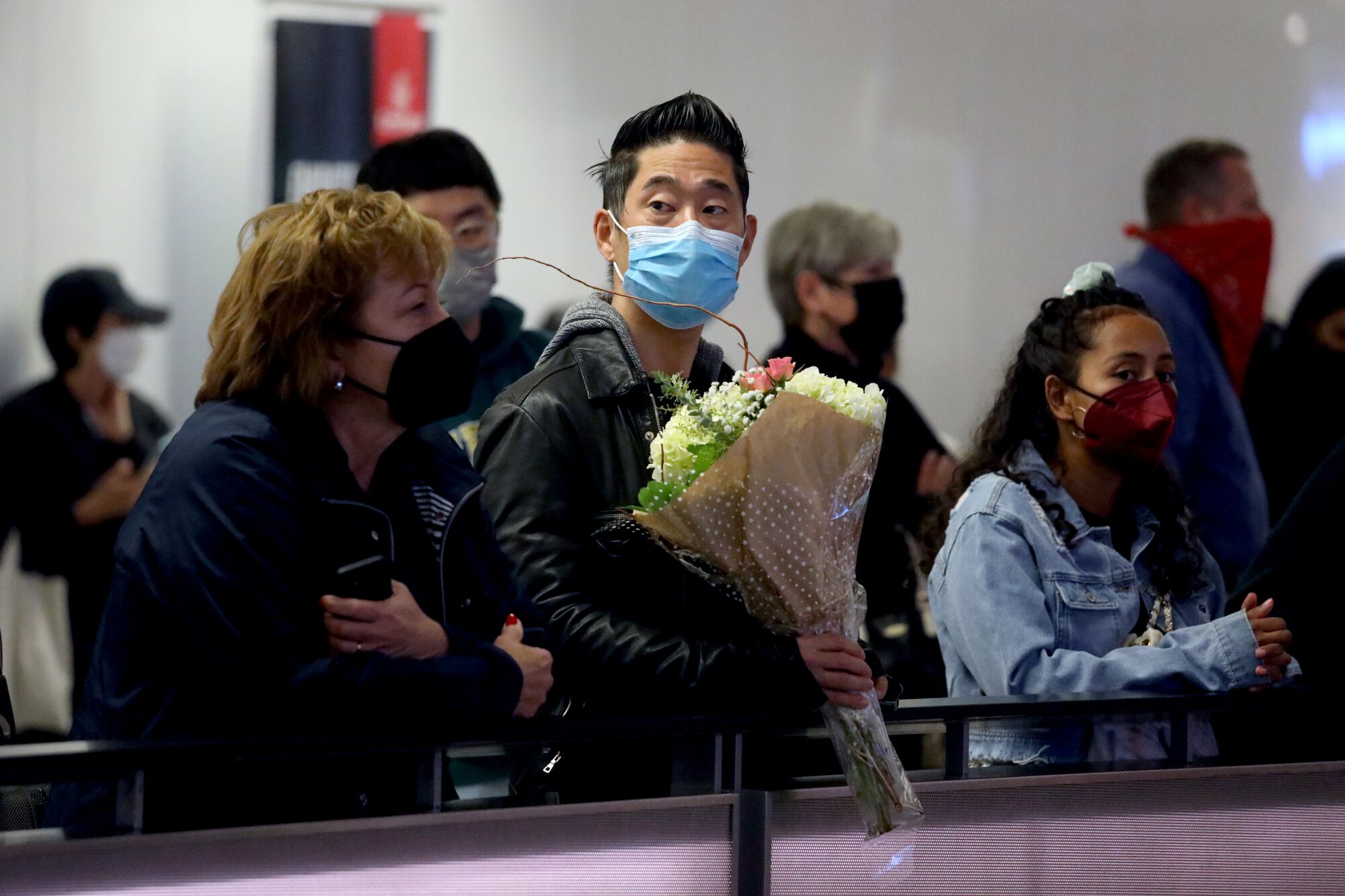 Sun Yun waits for his girlfriend to arrive at Tom Bradley International Terminal.