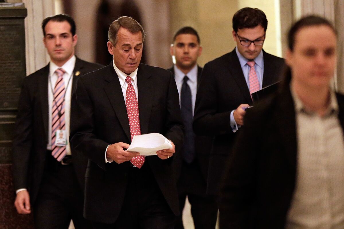 House Speaker John A. Boehner (R-Ohio) walks to the House chamber to vote on the bipartisan budget agreement.