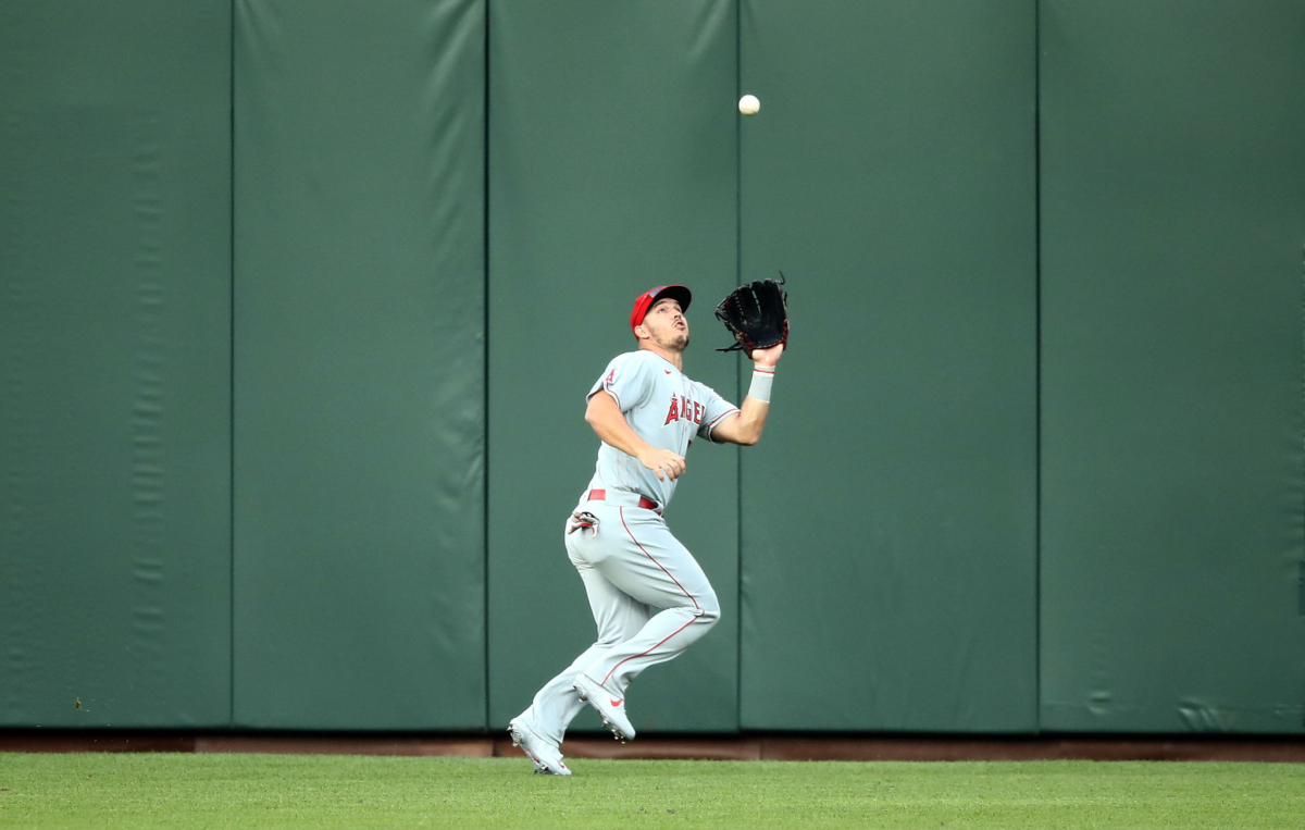 Mike Trout of the Angels catches a ball hit by Mike Yastrzemski of the San Francisco Giants at Oracle Park in August 2020.