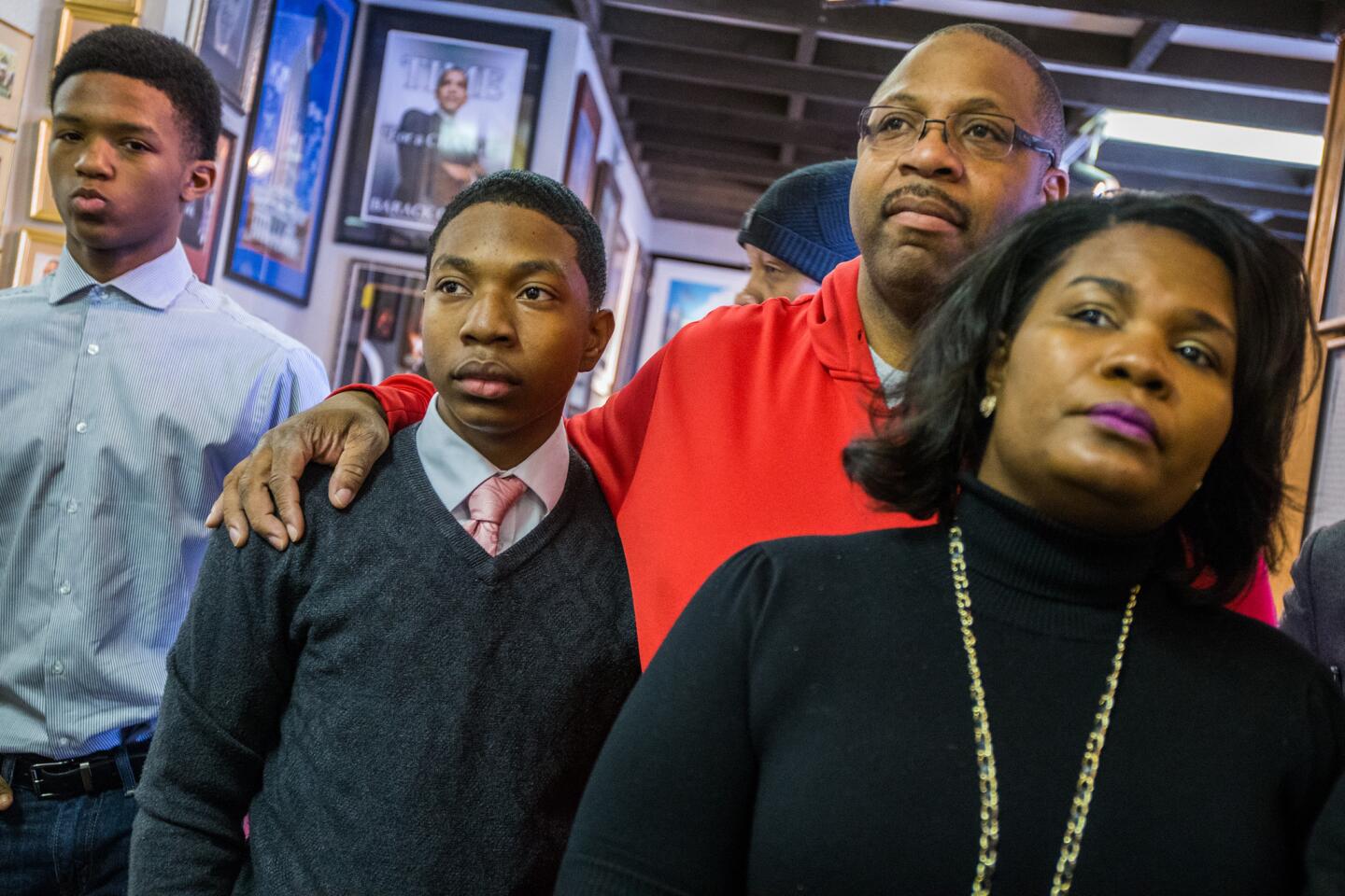 Former players Lawrence Noble, 14, left, Brandon Green, 14, and his parents, Christopher and Venisa Green, listen as attorney James A. Karamanis talks about a lawsuit on behalf of parents and former Little League baseball players from the Jackie Robinson West team in Chicago on Feb. 15, 2016. The Jackie Robinson West youth baseball team was stripped of the 2014 U.S. Little League championship title.