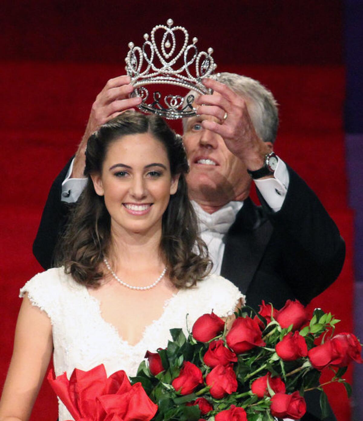 Rose Queen Ana Acosta is crowned by Pasadena Tournament of Roses President R. Scott Jenkins at the announcement and coronation of the 2014 Tournament of Roses Rose Queen at First Church of the Nazarene of Pasadena on Thursday, October 24, 2013. The Rose Queen is Ana Acosta of Polytechnic School in Pasadena. (Tim Berger/Staff Photographer)