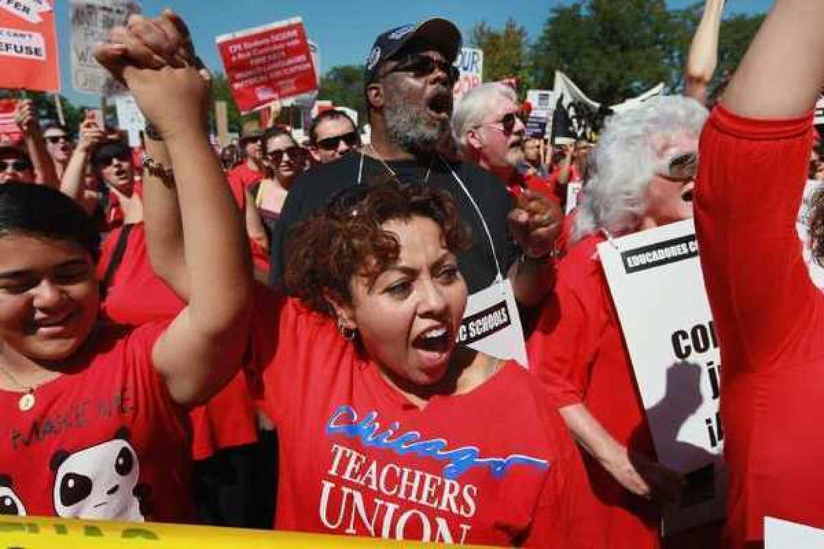 Striking teachers and their supporters rally at Union Park on Saturday in Chicago. The rally was a show of solidarity as negotiations on a labor contract continued.