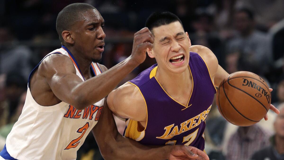 New York Knicks point guard Langston Galloway, left, fouls Lakers guard Jeremy Lin during the first half of Sunday's game at Madison Square Garden.