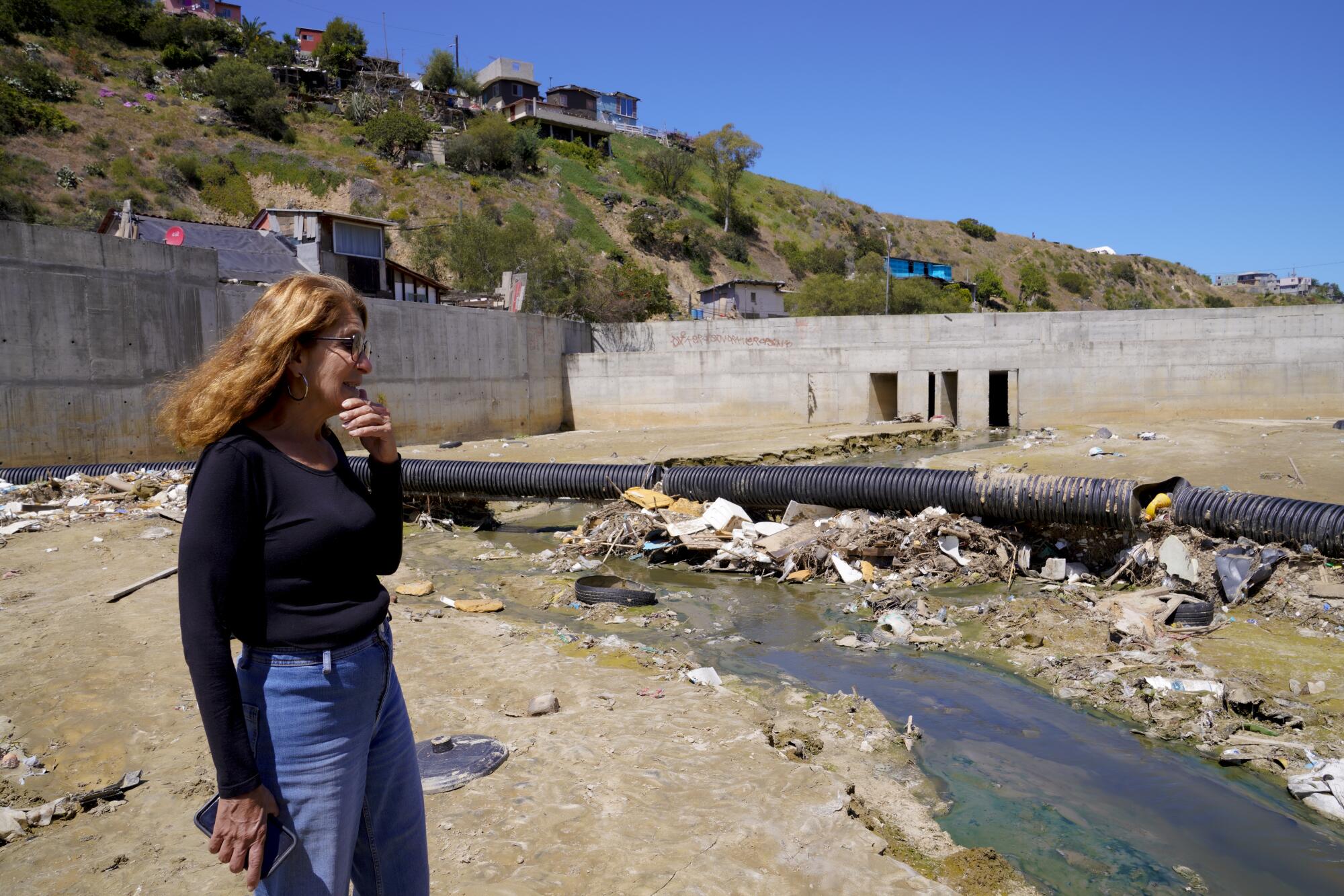 Fay Crevoshay, with local nonprofit Wildcoast, surveys a trash boom 