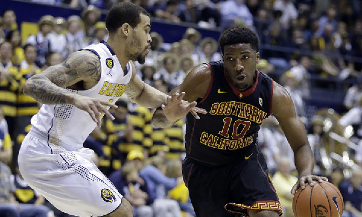 USC's Pe'Shon Howard, right, tries to drive past California's Justin Cobbs during the first half of Sunday's game.