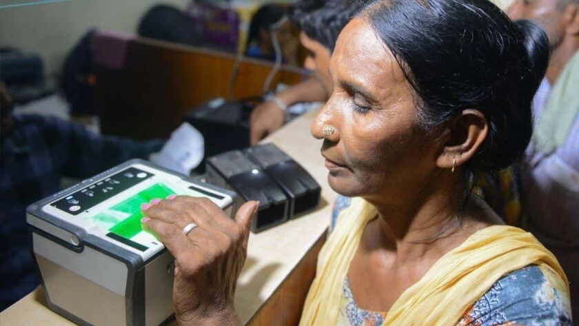 A woman has her fingerprints read during the registration process for Aadhaar in Amritsar, India.
