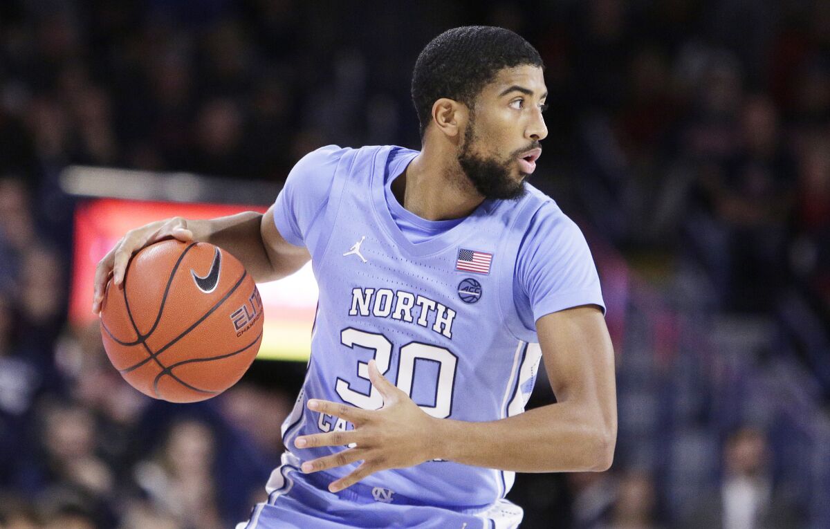 North Carolina guard K.J. Smith dribbles during a game.