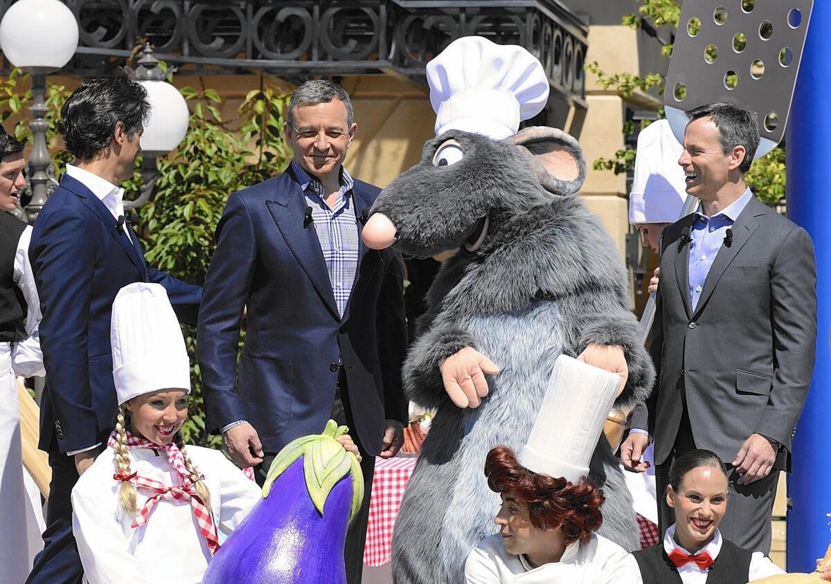 Disney CEO Robert Iger, center, and Chief Operating Officer Thomas Staggs, right, inaugurate a "Ratatouille" attraction at Disneyland Paris in 2014.