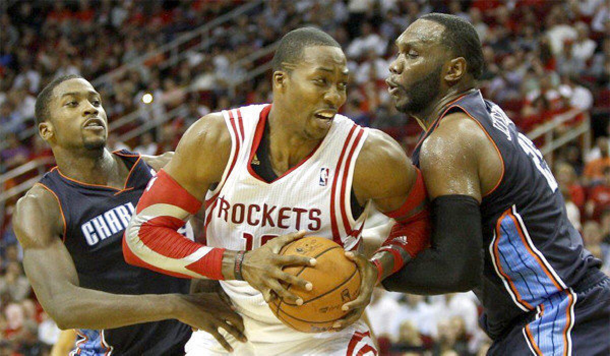 Houston center Dwight Howard, middle, is double-teamed by Charlotte's Al Jefferson, right, and Michael Kidd-Gilchrist. Howard squares off against the Lakers, his former team, this week.