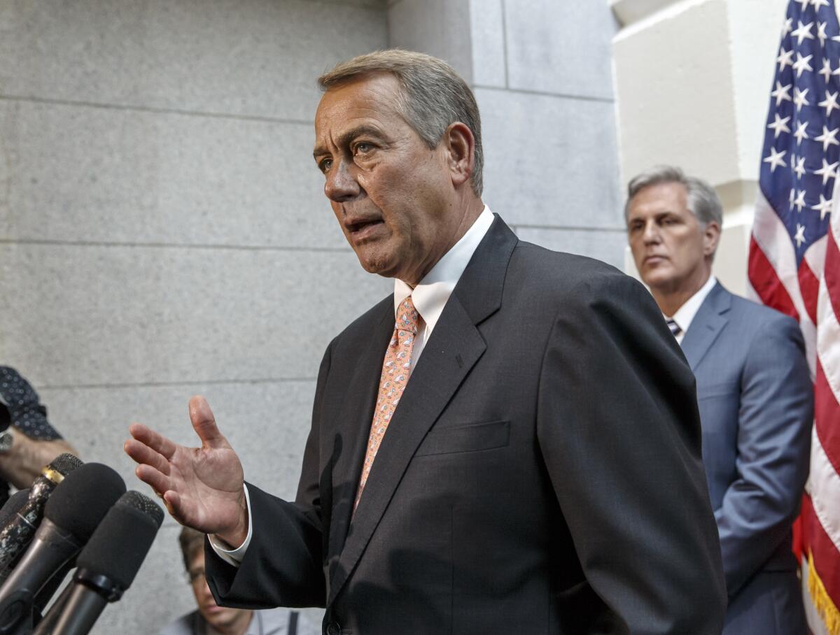 A senior White House official Friday said House Speaker John A. Boehner (R-Ohio), left, shown Monday with incoming Majority Leader Kevin McCarthy (R-Bakersfield), had "opened the door" to efforts to impeach President Obama.