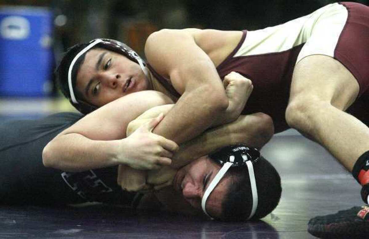 Anthony Landeros (132-pounder), in red, was one of six Spartans to notch pinfall victories against Hoover Tuesday.