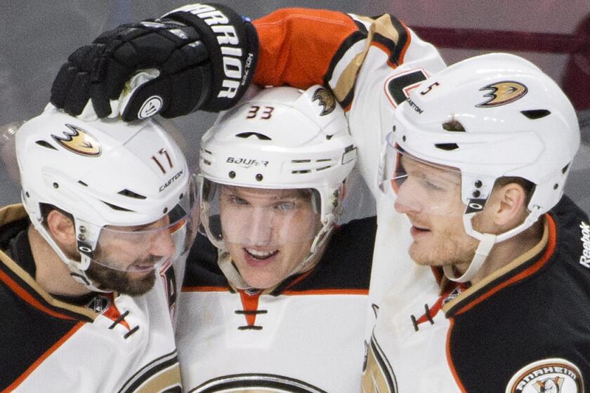 Ducks' Jakob Silfverberg, center, celebrates with teammates Ryan Kesler, left, and Korbinian Holzer after scoring against the Montreal Canadiens during second period Tuesday night.