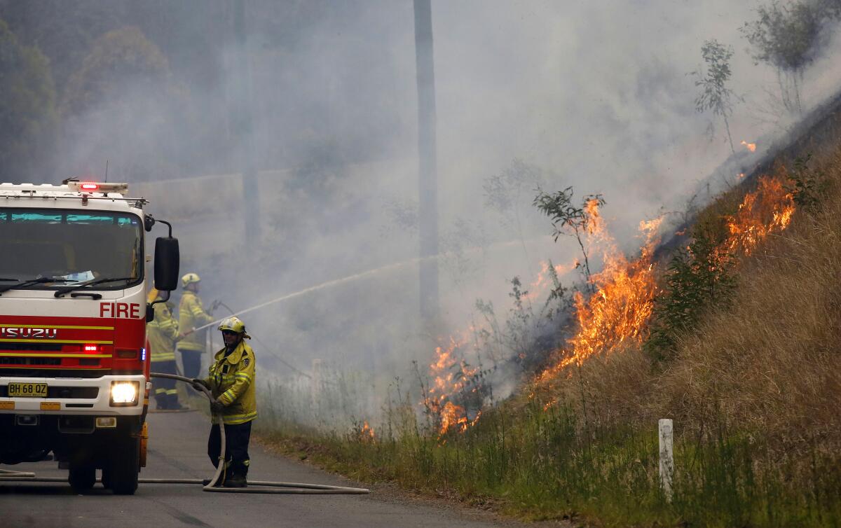 Australian firefighters work on a controlled burn in Koorainghat, New South Wales state on Monday.