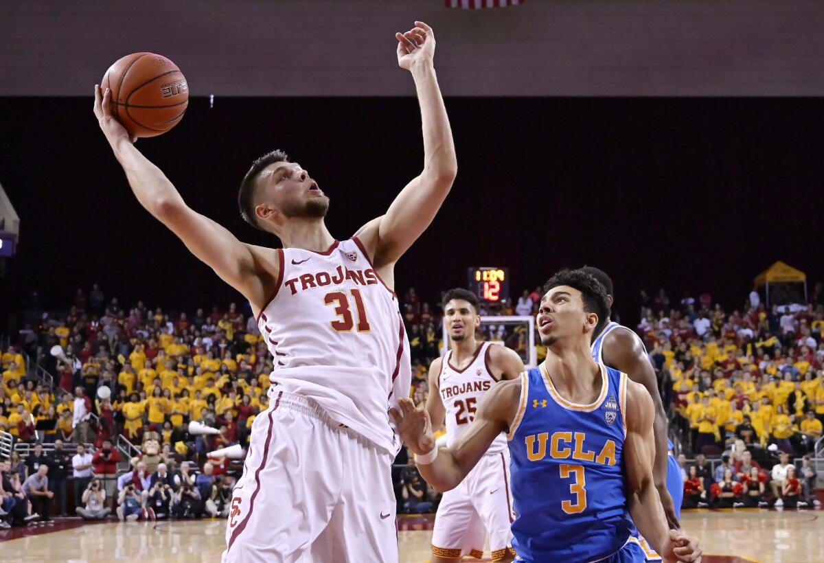 Basketball players Nick Rakocevic of USC and Jules Bernard of UCLA