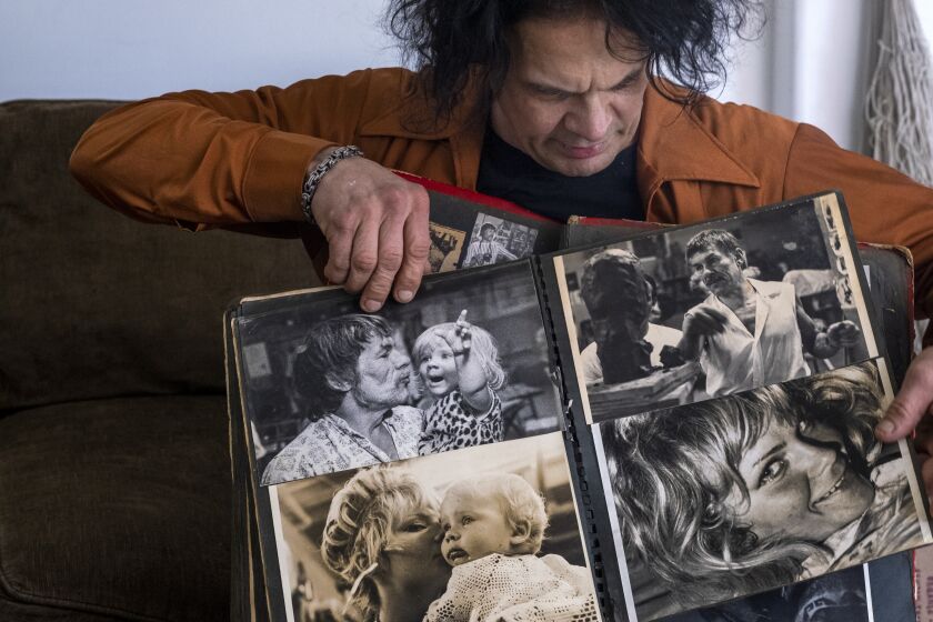 COTATI, CA - FEBRUARY 02: BB Paulekas, 52, shows his family photos in his livingroom on Wednesday, Feb. 2, 2022 in Cotati, CA. Vito Paulekas and his group of dancers, known as the Freaks helped create freeform dancing on the Sunset Strip in the 1960's. Paulekas was once known as "the first hippie" or "king of the hippies." BB Paulekas is Vito's son. (Francine Orr / Los Angeles Times)