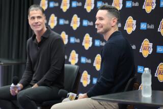 Lakers general manager Rob Pelinka and coach JJ Redick answer questions during a news conference in El Segundo