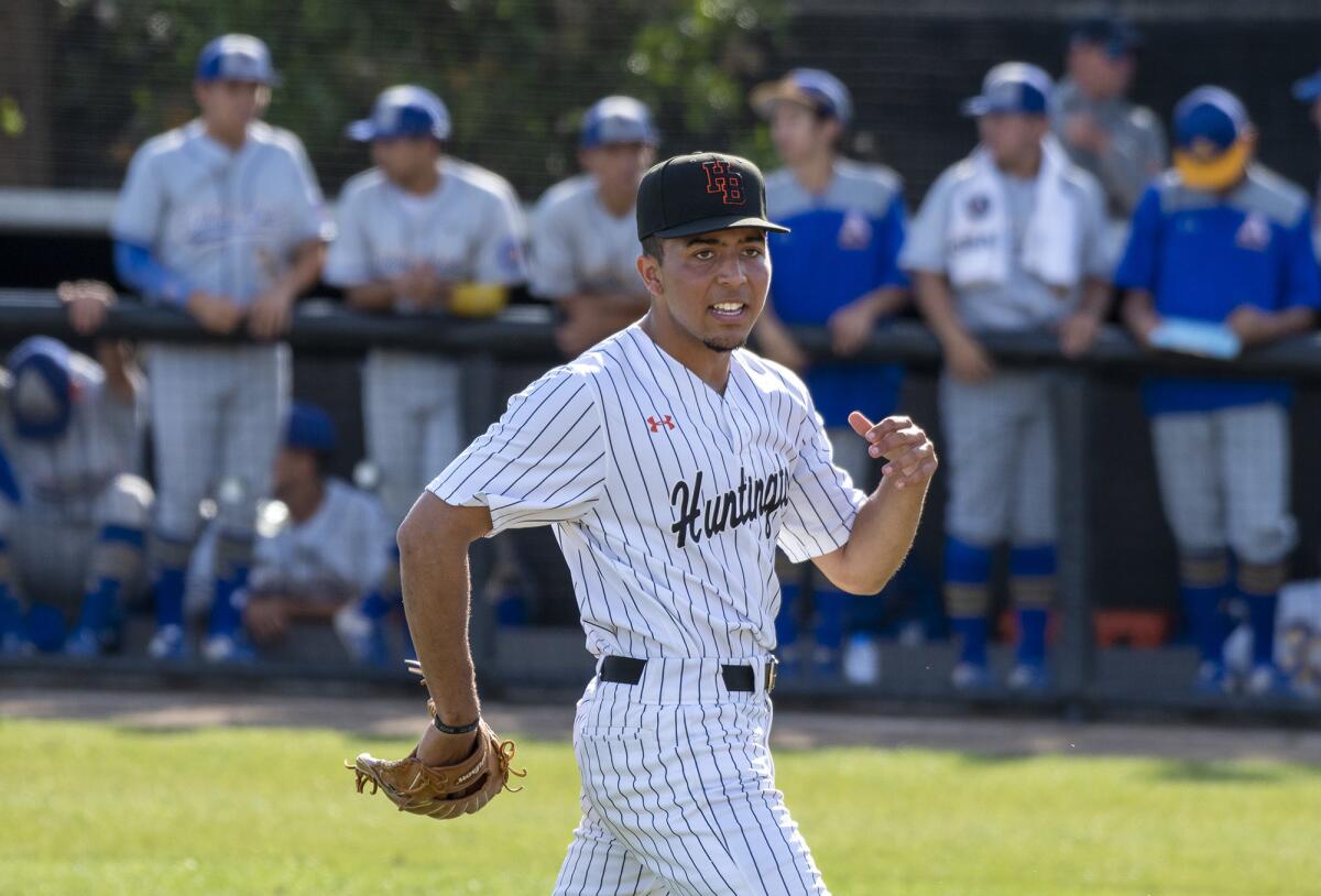 Huntington Beach High reliever Edward Pelc celebrates after getting out of the seventh inning against La Puente Bishop Amat in the second round of the CIF Southern Section Division 1 playoffs on Tuesday.