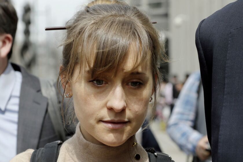 Actress Allison Mack leaves Brooklyn federal court Monday, April 8, 2019, in New York. Mack pleaded guilty to racketeering charges on Monday in a case involving a cult-like group based in upstate New York. The trial is expected to detail sensational allegations that the group, called NXIVM, recruited sex slaves for its spiritual leader, Keith Raniere.(AP Photo/Mark Lennihan)