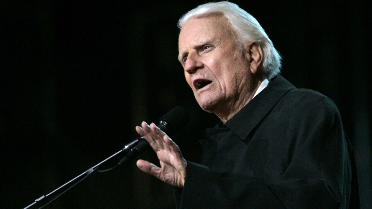 Billy Graham speaks to a crowd at the Rose Bowl on Nov. 18, 2004.