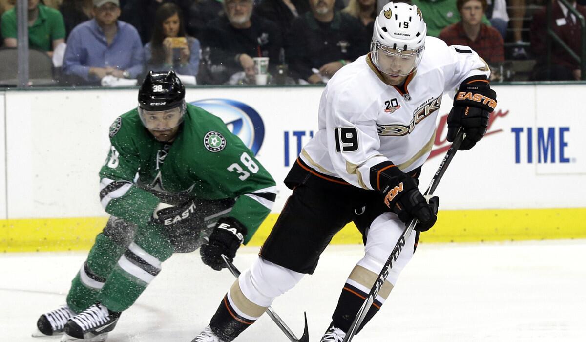 Anaheim Ducks defenseman Stephane Robidas collects a pass as Stars center Vernon Fiddler pursues the play in the first period Monday night in Dallas.