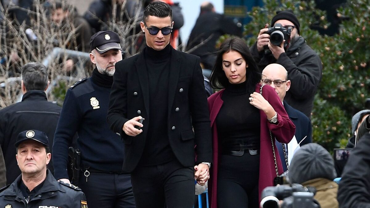 Cristiano Ronaldo leaves with girlfriend Georgina Rodriguez after attending a court hearing for tax evasion in Madrid on Jan. 22.