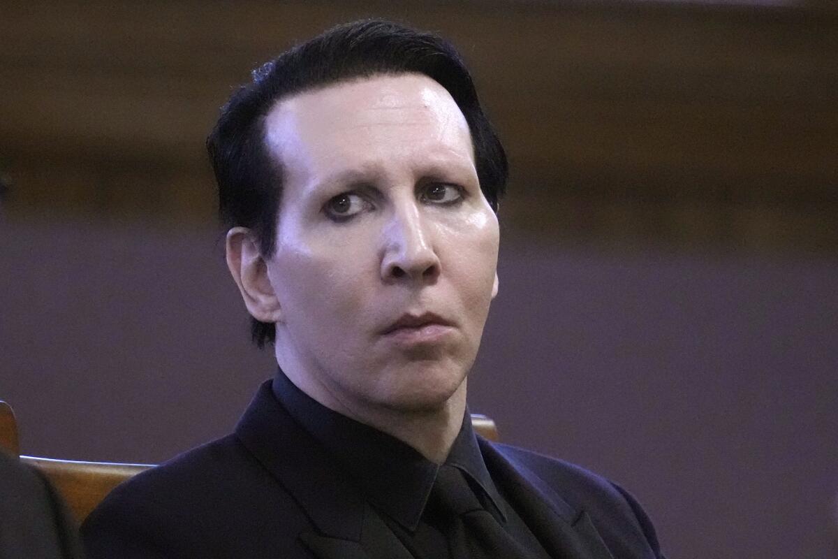 Marilyn Manson sitting in a courtroom