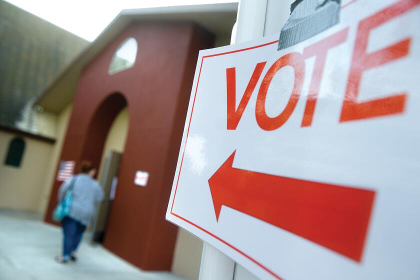 A sign points to a polling station at the First Baptist Church in Porterville on Nov. 4.