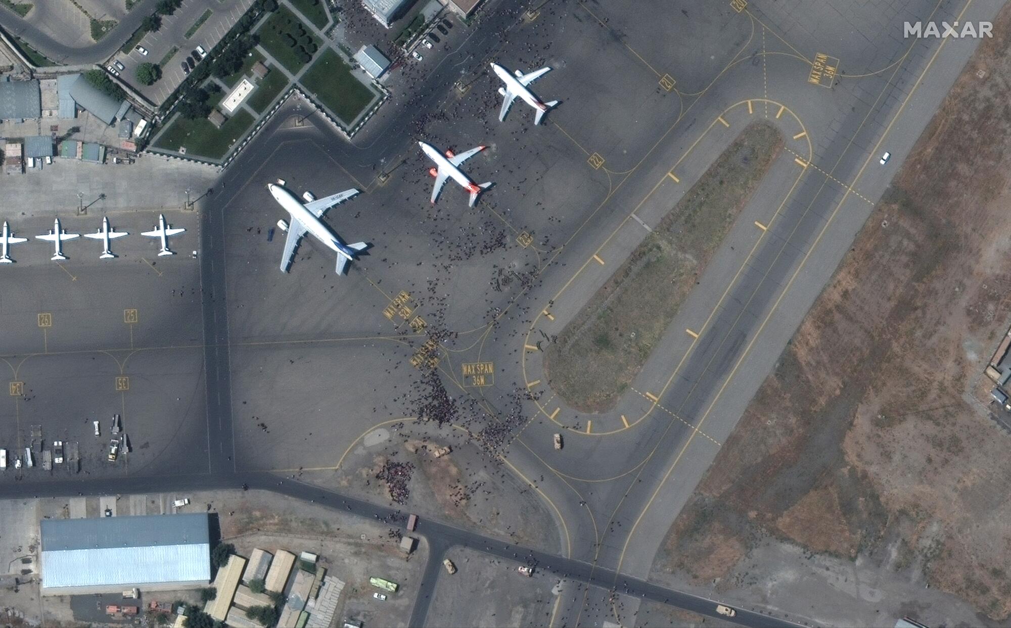 People thronging the airport tarmac in Kabul are visible from a satellite.