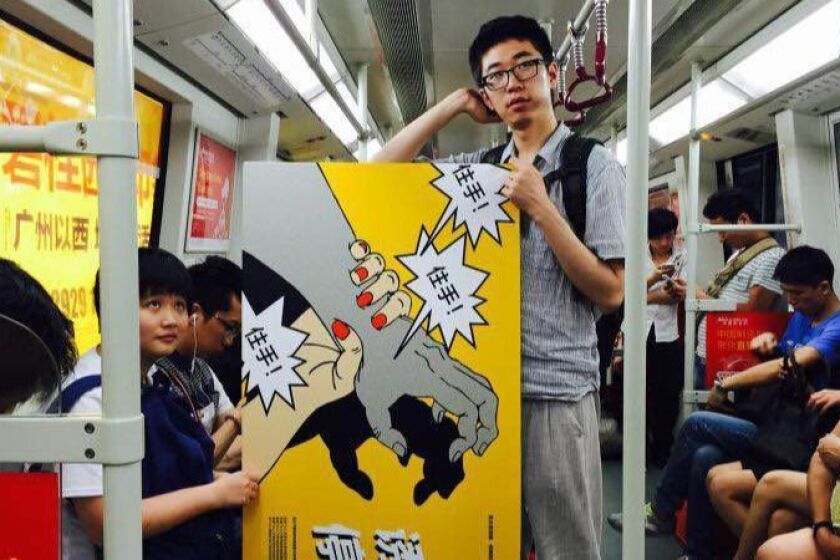 A feminist activist carries an anti-sexual harassment poster on the Guangzhou subway. (Photo courtesy of Xiao Meili)