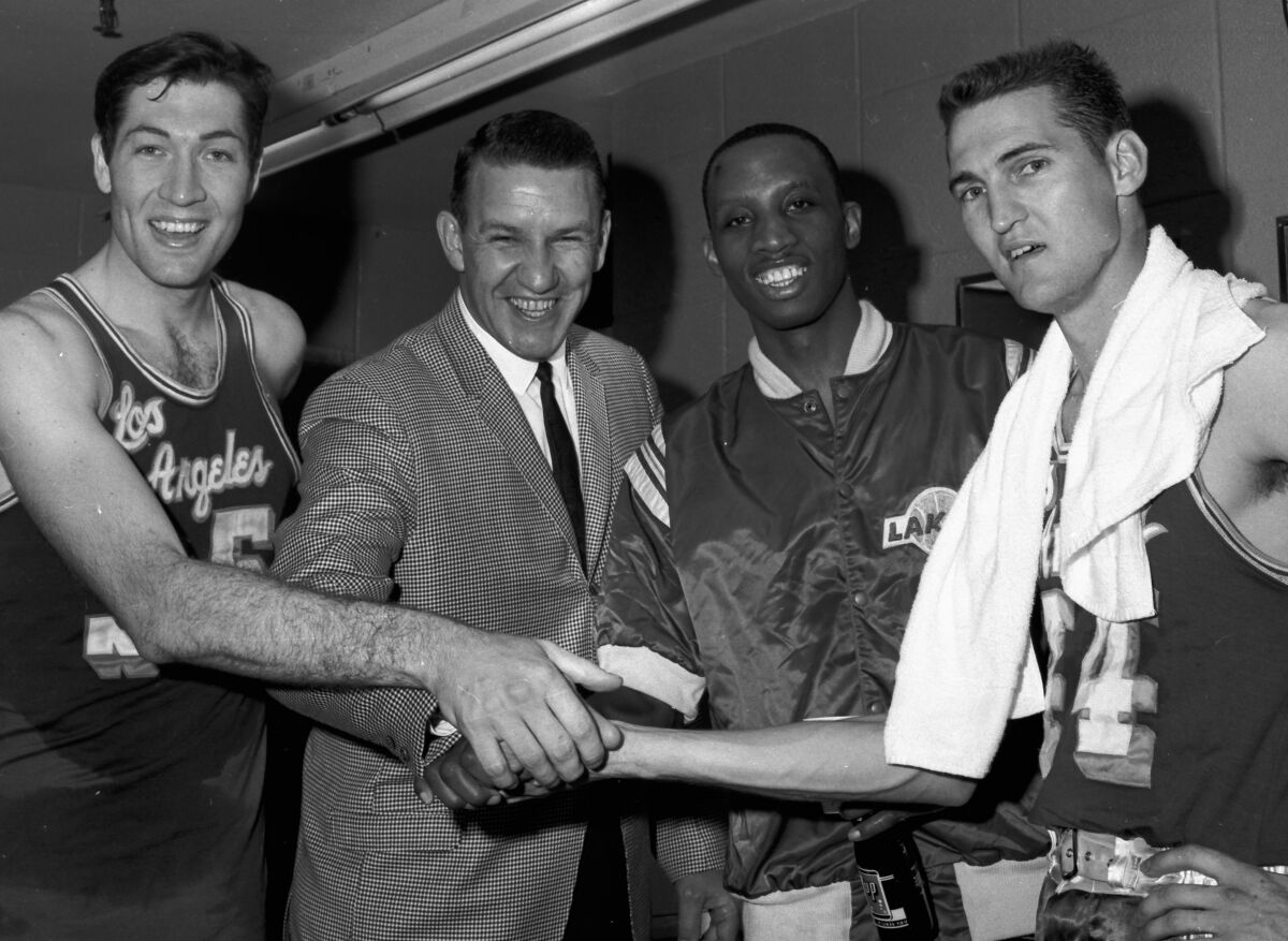 Lakers coach Fred Schaus, second from left, congratulates Rudy LaRusso, Dick Barnett and Jerry West