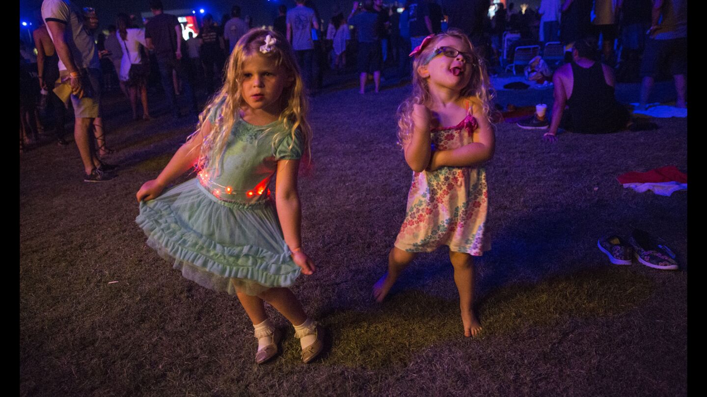 Rhya, 5, left, and Saydee, 3, Provensen of Huntington Beach dance to Neil Young at Desert Trip.