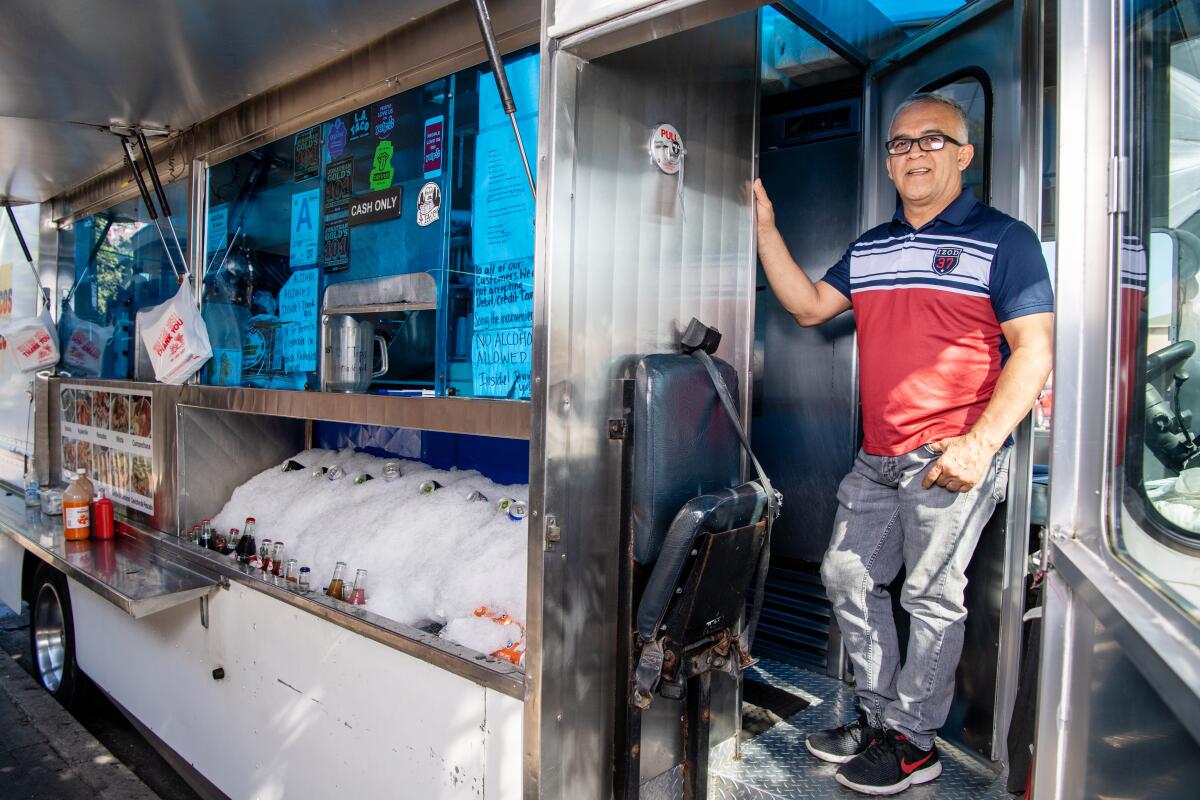 Mariscos Jaliscos owner Raul Ortega stands in the doorway of his food truck.