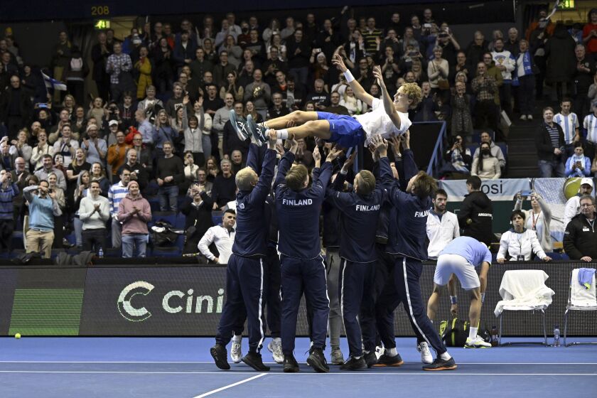 Emil Ruusuvuori of Finland is thrown into the air as Team Finland celebrate their 3-1 victory over Argentina in the 2023 tennis Davis Cup Finals qualifier between Finland and Argentina in Espoo, Finland, Sunday, Feb. 5, 2023. (Emmi Korhonen/Lehtikuva via AP)