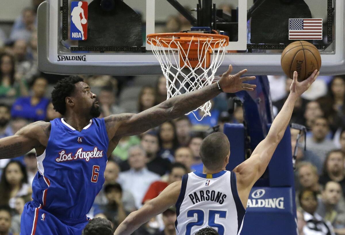 DeAndre Jordan defends the basket against Dallas forward Chandler Parsons on Monday night.