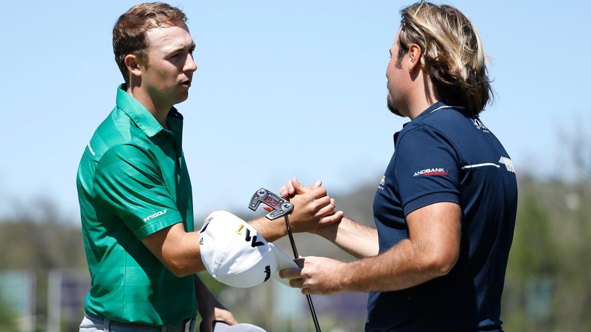 Jordan Spieth, left shakes hands with Victor Dubuisson after defeating the Frenchman during the second round of the WGC Dell Match Play tournament Thursday.