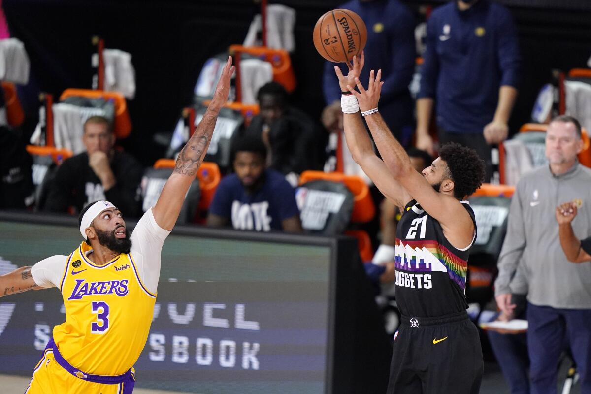 Lakers forward Anthony Davis challenges a shot by Nuggets guard Jamal Murray during Game 4.