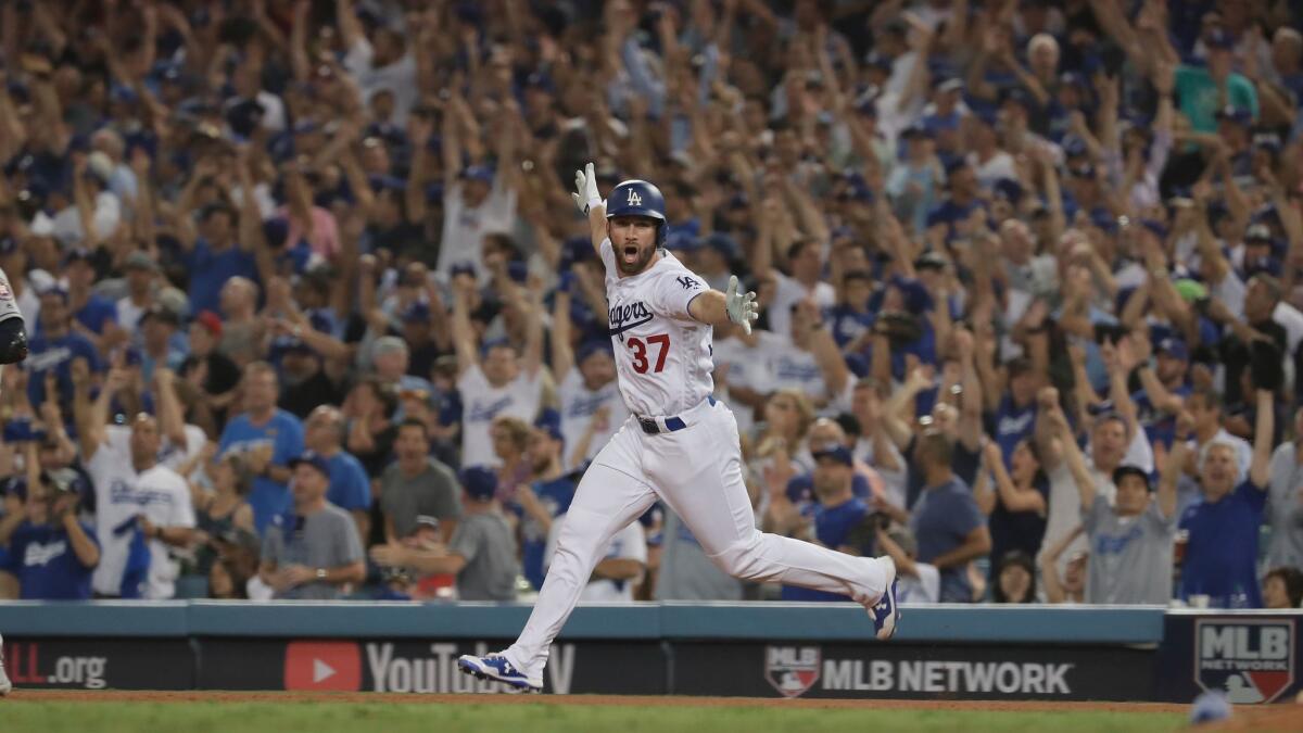 Dodgers left fielder Charlie Culberson celebrates as he circles the bases after hitting a home run in the 11th inning to cut the Dodgers' deficit to 7-6.