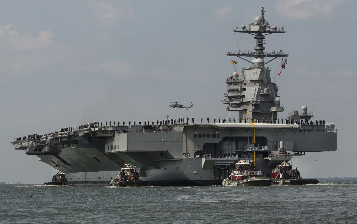 FILE - The aircraft carrier USS Gerald R. Ford heads to the Norfolk, Va., naval station on April 14, 2017. The USS Gerald R. Ford leaves the world's largest Navy base in Norfolk on Monday, Oct. 3, 2022, along with destroyers and other warships, the U.S. Navy said in a statement Thursday, Sept. 29, 2022. The carrier strike group will join ships in the Atlantic Ocean from countries that include France, Germany and Sweden for various exercises, such as anti-submarine warfare. (Bill Tiernan/The Virginian-Pilot via AP, File)