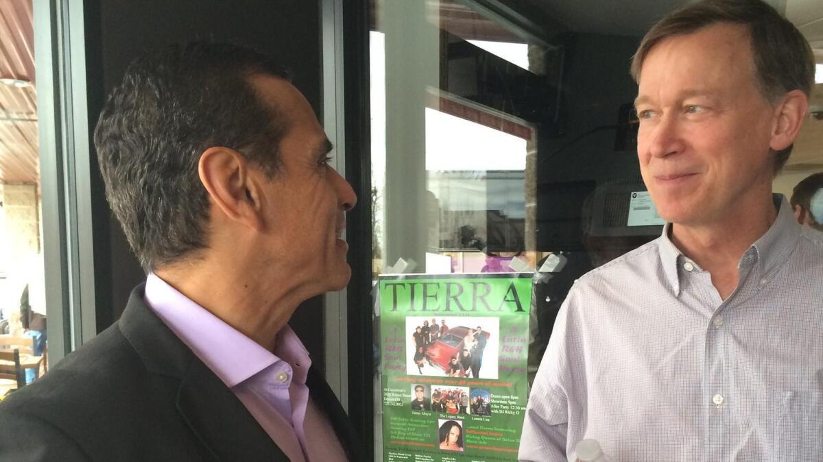 Former Los Angeles Mayor Antonio Villaraigosa, left, joins Colorado Gov. John Hickenlooper at the Tamales by La Casita restaurant in Denver.